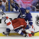 Detroit Red Wings defenseman Danny DeKeyser (65) and Tampa Bay Lightning center Cedric Paquette (13) collide during the second period of Game 7 of a first-round NHL Stanley Cup hockey playoff series Wednesday, April 29, 2015, in Tampa, Fla. (AP Photo/Chris O'Meara)