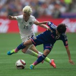 United States' Megan Rapinoe, left, and Japan's Homare Sawa fight for the ball during first half FIFA Women's World Cup soccer championship in Vancouver, British Columbia, Canada, Sunday, July 5, 2015. (Darryl Dyck/The Canadian Press via AP)
