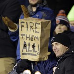 A Chicago Bears fan wears a paper bag during the second half of an NFL football game against the Dallas Cowboys Thursday, Dec. 4, 2014, in Chicago. (AP Photo/Nam Y. Huh)