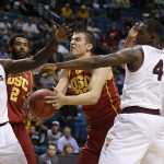 Southern California's Nikola Jovanovic, center, grabs a rebound over Arizona State's Savon Goodman (11) and Gerry Blakes (4) in the first half of an NCAA college basketball game in the first round of the Pac-12 Conference tournament Wednesday, March 11, 2015, in Las Vegas. (AP Photo/John Locher)