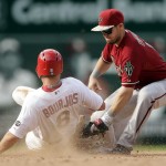 Arizona Diamondbacks second baseman Chris Owings, right, tags St. Louis Cardinals' Peter Bourjos out at second on a steal attempt during the eighth inning of a baseball game Monday, May 25, 2015, in St. Louis. (AP Photo/Jeff Roberson)