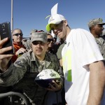 Green Bay Packers' Jordy Nelson has his picture taken with a fan after a practice session at Luke Air Force Base for the NFL Football Pro Bowl Thursday, Jan. 22, 2015, in Glendale, Ariz. (AP Photo/David J. Phillip)