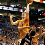 Phoenix Suns guard Goran Dragic (1) shoots over San Antonio Spurs guard Cory Joseph (5) in the second quarter during an NBA basketball game, Friday, Oct. 31, 2014, in Phoenix. (AP Photo/Rick Scuteri)