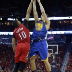 Golden State Warriors guard Klay Thompson (11) shoots against New Orleans Pelicans guard Eric Gordon (10) during the first half of Game 3 of a first-round NBA basketball playoff series in New Orleans, Thursday, April 23, 2015. (AP Photo/Gerald Herbert)