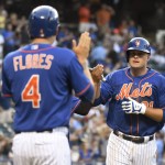 New York Mets' Lucas Duda, right, celebrates with Ruben Tejada and Wilmer Flores (4) after Duda hit a three-run home run during the first inning of a baseball game against the Arizona Diamondbacks on Friday, July 10, 2015, at Citi Field in New York. (AP Photo/Bill Kostroun)
