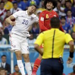 United States' Geoff Cameron (20) goes for a header with Belgium's Marouane Fellaini (8) during the World Cup round of 16 soccer match between Belgium and the USA at the Arena Fonte Nova in Salvador, Brazil, Tuesday, July 1, 2014. (AP Photo/Felipe Dana)