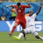  Switzerland's Josip Drmic, left, is challenged by Honduras' Brayan Beckeles during the group E World Cup soccer match between Honduras and Switzerland at the Arena da Amazonia in Manaus, Brazil, Wednesday, June 25, 2014. (AP Photo/Kirsty Wigglesworth)