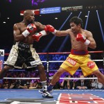 Manny Pacquiao, right, from the Philippines, trades blows with Floyd Mayweather Jr., during their welterweight title fight on Saturday, May 2, 2015 in Las Vegas. (AP Photo/John Locher)
