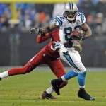 Carolina Panthers' Jerricho Cotchery (82) runs after a catch as Arizona Cardinals' Antonio Cromartie (31) defends in the first half of an NFL wild card playoff football game in Charlotte, N.C., Saturday, Jan. 3, 2015. (AP Photo/Mike McCarn)
