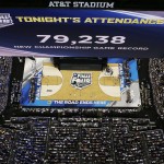 The big screen shows the number of people in attendance during the second half of the NCAA Final Four tournament college basketball championship game between Connecticut and Kentucky Monday, April 7, 2014, in Arlington, Texas. (AP Photo/David J. Phillip)