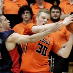 Arizona guard T.J. McConnell, left, plays tight defense on Oregon State forward Olaf Schaftenaar during the first half of an NCAA college basketball game in Corvallis, Ore., Sunday, Jan. 11, 2015. (AP Photo/Don Ryan)

