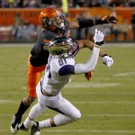 Oklahoma State cornerback Kevin Peterson breaks up a pass intended for Washington wide receiver Brayden Lenius (81) during the second half of the Cactus Bowl NCAA college football game, Friday, Jan. 2, 2015, in Tempe, Ariz. (AP Photo/Matt York)
