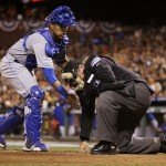 Kansas City Royals Salvador Perez helps home plate umpire Hunter Wendelstedt after Wendelstedt was hit by a foul tip during the seventh inning of Game 5 of baseball's World Series against the San Francisco Giants Sunday, Oct. 26, 2014, in San Francisco. (AP Photo/Matt Slocum)