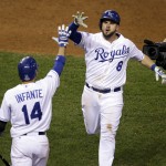 Kansas City Royals' Mike Moustakas is congratulated after hitting a home run during the seventh inning of Game 6 of baseball's World Series against the San Francisco Giants Tuesday, Oct. 28, 2014, in Kansas City, Mo. (AP Photo/Jeff Roberson)