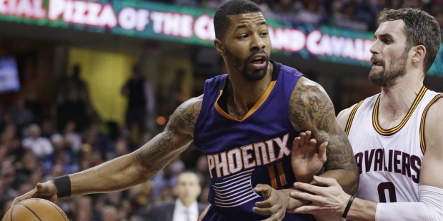 Phoenix Suns’ Markieff Morris, left, drives past Cleveland Cavaliers’ Kevin Love during...