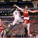 Duke's Grayson Allen (3) drives to the basket between Wisconsin defenders Josh Gasser, left, and Frank Kaminsky, right, during the first half of the NCAA Final Four college basketball tournament championship game Monday, April 6, 2015, in Indianapolis. (AP Photo/Michael Conroy)
