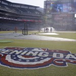 The Comerica Park grounds crew waters the infield before an opening day baseball game between the Detroit Tigers and the Minnesota Twins in Detroit, Monday, April 6, 2015. (AP Photo/Carlos Osorio)