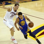 Golden State Warriors guard Stephen Curry (30) drives against Cleveland Cavaliers center Timofey Mozgov (20) during the first half of Game 6 of basketball's NBA Finals in Cleveland, Tuesday, June 16, 2015. (AP Photo/Paul Sancya)