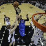  Dallas Mavericks' Monta Ellis (11) drives to the basket between San Antonio Spurs' Matt Bonner, left, and Tim Duncan, right, during the first quarter of Game 1 of the opening-round NBA basketball playoff series, Sunday, April 20, 2014, in San Antonio. (AP Photo/Eric Gay)