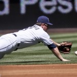 San Diego Padres second baseman Jedd Gyorko misses on the diving attempt for a single by Arizona Diamondbacks' Ender Inciarte in the first inning of a baseball game Monday, Sept. 1, 2014, in San Diego. (AP Photo/Lenny Ignelzi)
