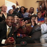 Jameis Winston reacts with his family and friends as he takes the call from the Tampa Bay Buccaneers that they are selecting him as the number one draft pick, Thursday, April 30, 2015, in Bessemer, Ala. (AP Photo/Butch Dill)