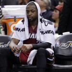 Miami Heat guard Dwyane Wade sits on the sideline against the San Antonio Spurs during the second half in Game 1 of the NBA basketball finals on Thursday, June 5, 2014 in San Antonio. San Antonio won 110-95. (AP Photo/Eric Gay)