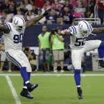 Indianapolis Colts' Cory Redding (90) and D'Qwell Jackson (52) celebrate after they sacked Houston Texans' Ryan Fitzpatrick during the first quarter of an NFL football game, Thursday, Oct. 9, 2014, in Houston. (AP Photo/David J. Phillip)