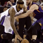 Sacramento Kings center DeMarcus Cousins, left, drives against Phoenix Suns center Miles Plumlee during the first quarter of an NBA basketball game in Sacramento Calif., Sunday, Feb. 8, 2015.(AP Photo/Rich Pedroncelli)
