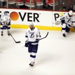 Members of the Tampa Bay Lightning, from left, to right, Jonathan Drouin, Tyler Johnson, Braydon Coburn and Jason Garrison pause after being defeated by the Chicago Blackhawks in Game 6 of the NHL hockey Stanley Cup Final series on Monday, June 15, 2015, in Chicago. The Blackhawks won 2-0 to take the series 4-2. (AP Photo/Charles Rex Arbogast)
