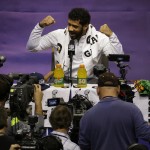 Seattle Seahawks' Russell Wilson gestures during media day for NFL Super Bowl XLIX football game Tuesday, Jan. 27, 2015, in Phoenix. (AP Photo/Charlie Riedel)
