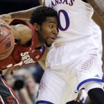 Stanford's Chasson Randle, left, tries to maneuver around Kansas' Naadir Tharpe, right, during the first half of a third-round game of the NCAA college basketball tournament Sunday, March 23, 2014, in St. Louis. (AP Photo/Jeff Roberson)