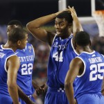 Kentucky players Aaron Harrison (2), Alex Poythress (22), Dakari Johnson (44), and Dominique Hawkins (25) huddle against Wisconsin during the first half of the NCAA Final Four tournament college basketball semifinal game Saturday, April 5, 2014, in Arlington, Texas. (AP Photo/David J. Phillip)