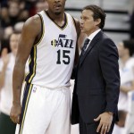 Utah Jazz' head coach Quin Snyder talks with his player Derrick Favors during the second half of an NBA basketball game in Salt Lake City, Saturday, Nov. 1, 2014. The Jazz defeated the Suns 118-91. (AP Photo/George Frey)