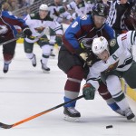 Minnesota Wild left wing Zach Parise (11) ducks under Colorado Avalanche defenseman Jan Hejda (8), from the Czech Republic, during the first period in Game 1 of an NHL hockey first-round playoff series on Thursday, April 17, 2014, in Denver. (AP Photo/Jack Dempsey)
