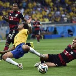 Brazil's Marcelo goes down in the box but gets no penalty during the World Cup semifinal soccer match between Brazil and Germany at the Mineirao Stadium in Belo Horizonte, Brazil, Tuesday, July 8, 2014. At right is Germany's Philipp Lahm. (AP Photo/Martin Meissner)