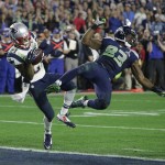 New England Patriots strong safety Malcolm Butler (21) intercepts a pass intended for Seattle Seahawks wide receiver Ricardo Lockette (83) during the second half of NFL Super Bowl XLIX football game Sunday, Feb. 1, 2015, in Glendale, Ariz. (AP Photo/Kathy Willens)