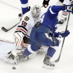 Chicago Blackhawks goalie Corey Crawford (50) kicks away a shot by Tampa Bay Lightning left wing Ondrej Palat (18) during the third period of Game 5 of the NHL hockey Stanley Cup Final, Saturday, June 13, 2015, in Tampa, Fla. (AP Photo/John Raoux)