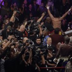 Floyd Mayweather Jr., bottom right, watches as Manny Pacquiao, from the Philippines, waves to the crowd at upper right after their welterweight title fight on Saturday, May 2, 2015 in Las Vegas. (AP Photo/Eric Jamison)
