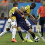 Netherlands' Arjen Robben is held by Brazil's Luiz Gustavo, left, and Ramires along the sidelines during the World Cup third-place soccer match between Brazil and the Netherlands at the Estadio Nacional in Brasilia, Brazil, Saturday, July 12, 2014. (AP Photo/Natacha Pisarenko)