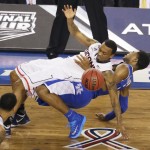 Connecticut guard Ryan Boatright, left, and Kentucky guard Andrew Harrison fight for a loose ball during the second half of the NCAA Final Four tournament college basketball championship game Monday, April 7, 2014, in Arlington, Texas. (AP Photo/Tony Gutierrez)