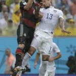 Germany's Benedikt Hoewedes, left, and United States' Jermaine Jones go for a header during the group G World Cup soccer match between the USA and Germany at the Arena Pernambuco in Recife, Brazil, Thursday, June 26, 2014. (AP Photo/Matthias Schrader)
