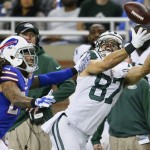 New York Jets wide receiver Eric Decker (87) pulls in a pass while defended by Buffalo Bills cornerback Stephon Gilmore (24) during the second half of an NFL football game in Detroit, Monday, Nov.24, 2014. (AP Photo/Rick Osentoski)