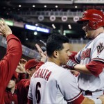  Arizona Diamondbacks' Mark Trumbo, right, is welcomed in the dugout after his two-run home run off Minnesota Twins pitcher Ricky Nolasco in the fifth inning of a baseball game, Monday, Sept. 22, 2014, in Minneapolis. (AP Photo/Jim Mone)
