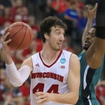 Wisconsin's Frank Kaminsky (44) passes the ball around Coastal Carolina's Josh Cameron (3) during the second half of an NCAA tournament college basketball game in the Round of 64 in Omaha, Neb., Friday, March 20, 2015. (AP Photo/Nati Harnik)