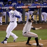 San Francisco Giants' Brandon Belt, right, can't handle the throw as Kansas City Royals' Salvador Perez is safe at first during the fourth inning of Game 6 of baseball's World Series Tuesday, Oct. 28, 2014, in Kansas City, Mo. (AP Photo/Charlie Riedel)