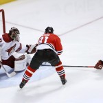 Arizona Coyotes goalie Mike Smith (41) makes a save on a shot by Chicago Blackhawks right wing Marian Hossa (81) as Oliver Ekman-Larsson also defends during the first period of an NHL hockey game Monday, Feb. 9, 2015, in Chicago. (AP Photo/Charles Rex Arbogast)