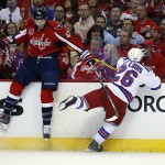 Washington Capitals right wing Tom Wilson (43) and New York Rangers right wing Martin St. Louis (26) collide against the boards during the first period of Game 3 in the second round of the NHL Stanley Cup hockey playoffs, Monday, May 4, 2015, in Washington. (AP Photo/Alex Brandon)