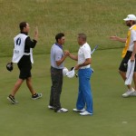 Rickie Fowler of the US, second left, shakes hands with Sergio Garcia of Spain on the 18th green at the end of their match on the third day of the British Open Golf championship at the Royal Liverpool golf club, Hoylake, England, Saturday July 19, 2014. (AP Photo/Peter Morrison)