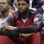 Miami Heat forward LeBron James watches action from the bench against the San Antonio Spurs during the first half in Game 2 of the NBA basketball finals on Sunday, June 8, 2014, in San Antonio. (AP Photo/Eric Gay)
