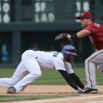  Arizona Diamondbacks first baseman Paul Goldschmidt, right, fields pickoff throw as Colorado Rockies' Charlie Blackmon scrambles back to first base in the first inning of a baseball game in Denver on Sunday, April 6, 2014. (AP Photo/David Zalubowski)